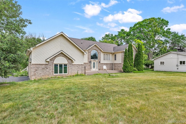 969 Bogie Lake Rd, White Lake, MI 48383 - view of front of home with brick siding and a front lawn