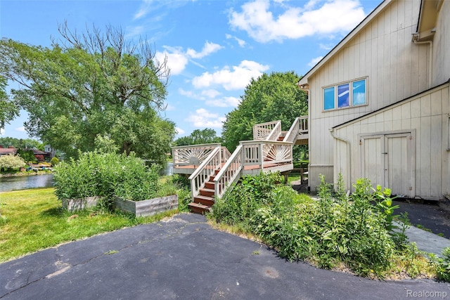 969 Bogie Lake Rd, White Lake, MI 48383 - view of yard with stairway and a deck with water view