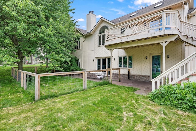 969 Bogie Lake Rd, White Lake, MI 48383 - rear view of house with a yard, a chimney, and a wooden deck