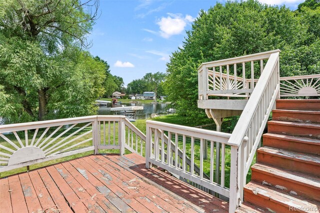 969 Bogie Lake Rd, White Lake, MI 48383 - wooden deck with a water view, stairs, and view of wooded area