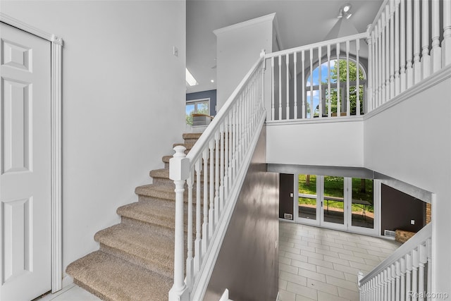969 Bogie Lake Rd, White Lake, MI 48383 - staircase with a towering ceiling, healthy amount of natural light, and tile patterned flooring