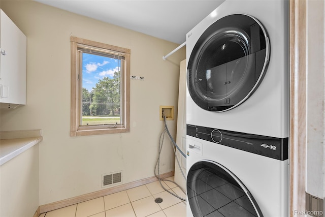 969 Bogie Lake Rd, White Lake, MI 48383 - laundry room with estacked washer and dryer and light tile patterned floors