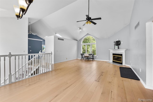969 Bogie Lake Rd, White Lake, MI 48383 - unfurnished living room with a ceiling fan, a tile fireplace, hardwood / wood-style floors, and vaulted ceiling