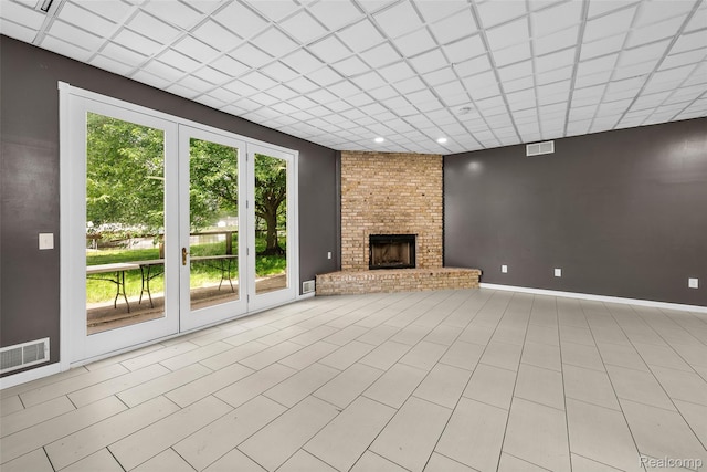 969 Bogie Lake Rd, White Lake, MI 48383 - unfurnished living room with plenty of natural light and a brick fireplace