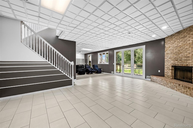 969 Bogie Lake Rd, White Lake, MI 48383 - unfurnished living room with stairway, a brick fireplace, and recessed lighting