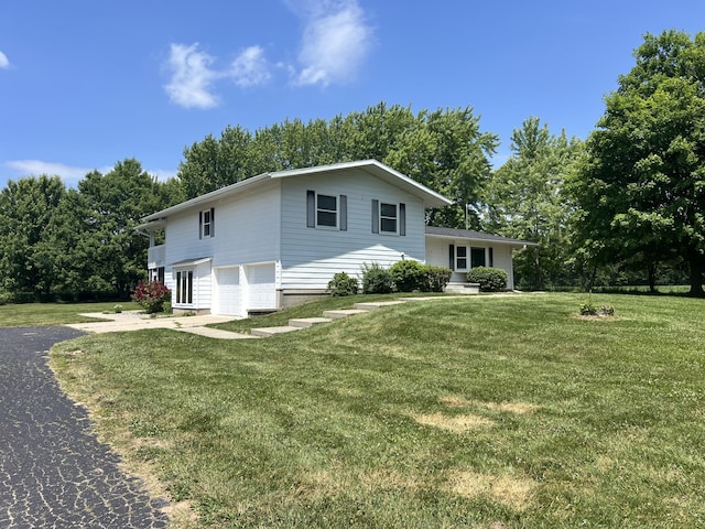 7567 S Bignham Ave, Newaygo, MI 49337 - view of front of house with a garage, driveway, a front lawn, and view of scattered trees