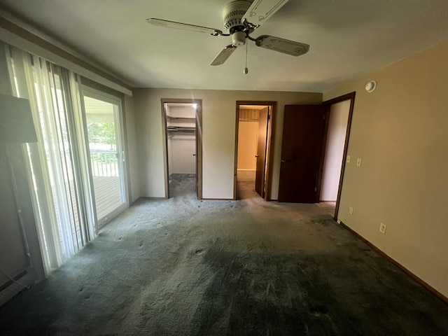 7567 S Bignham Ave, Newaygo, MI 49337 - unfurnished bedroom featuring carpet flooring, ceiling fan, a walk in closet, and access to exterior