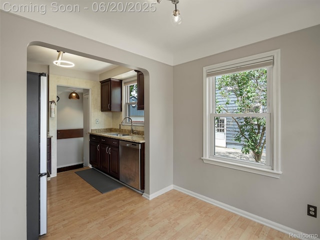3299 Goodrich St, Ferndale, MI 48220 - kitchen featuring arched walkways, dishwasher, dark brown cabinets, and plenty of natural light