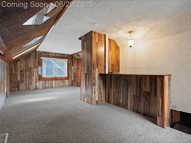 3299 Goodrich St, Ferndale, MI 48220 - additional living space featuring wood walls, carpet flooring, lofted ceiling, a textured ceiling, and a skylight