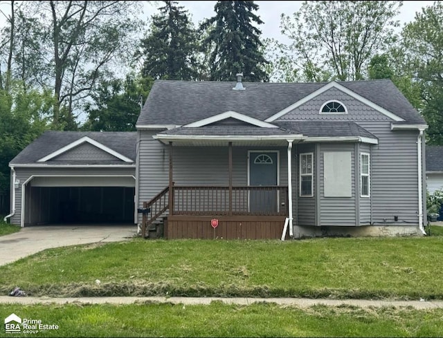 2449 Gibson St, Flint, MI 48503 - view of front facade with covered porch, an attached garage, concrete driveway, a front yard, and roof with shingles