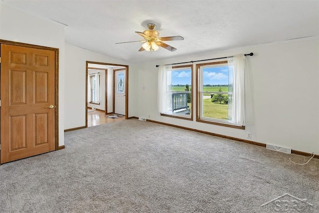 3227 S 11 Mile Rd, Auburn, MI 48611 - carpeted empty room featuring a ceiling fan and lofted ceiling