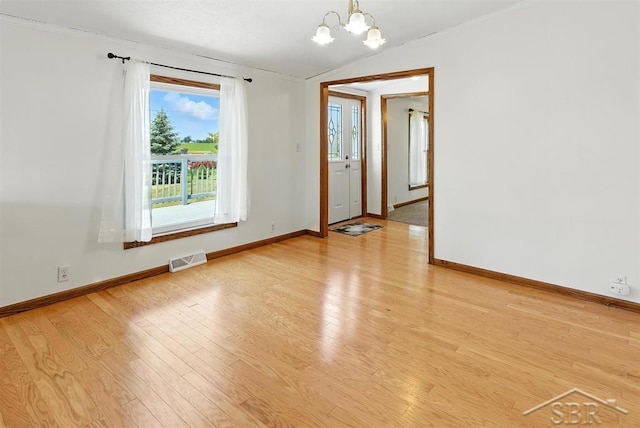 3227 S 11 Mile Rd, Auburn, MI 48611 - spare room with a chandelier, light wood-type flooring, and ornamental molding