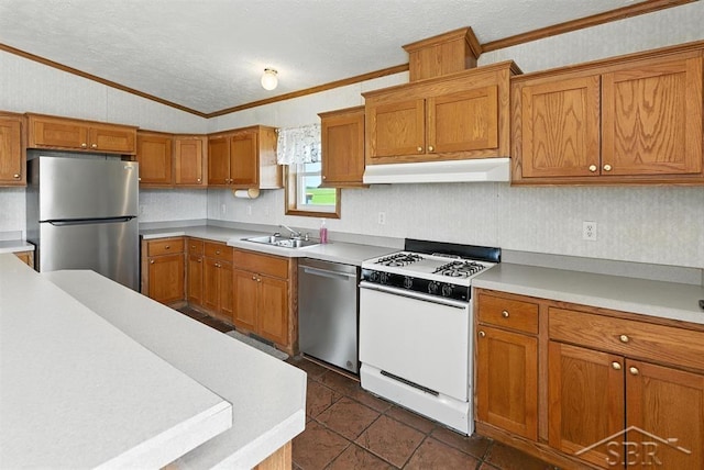 3227 S 11 Mile Rd, Auburn, MI 48611 - kitchen with stainless steel appliances, under cabinet range hood, ornamental molding, lofted ceiling, and brown cabinetry