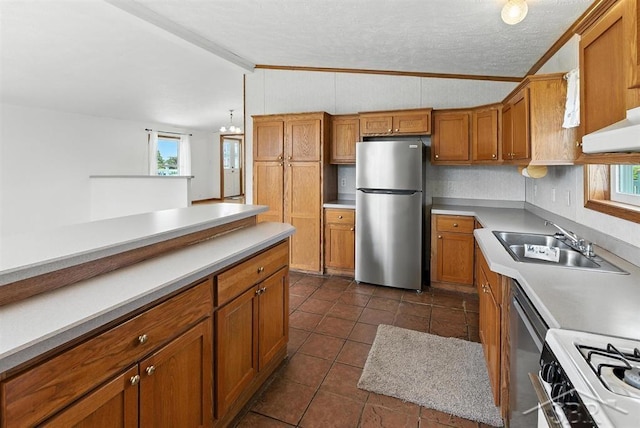 3227 S 11 Mile Rd, Auburn, MI 48611 - kitchen with stainless steel appliances, brown cabinets, ornamental molding, light countertops, and lofted ceiling