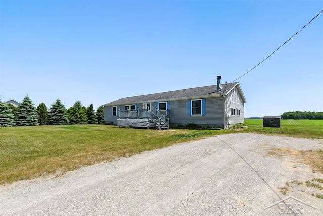3227 S 11 Mile Rd, Auburn, MI 48611 - view of front facade featuring a front yard and a deck