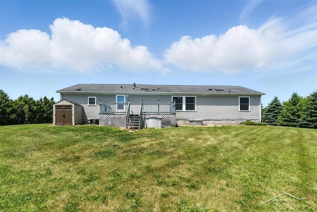 3227 S 11 Mile Rd, Auburn, MI 48611 - rear view of house with a shed, a deck, and a yard