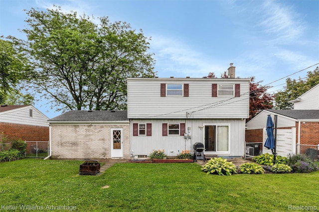 9286 Dudley St, Taylor, MI 48180 - back of property with a chimney, a patio, and a fire pit