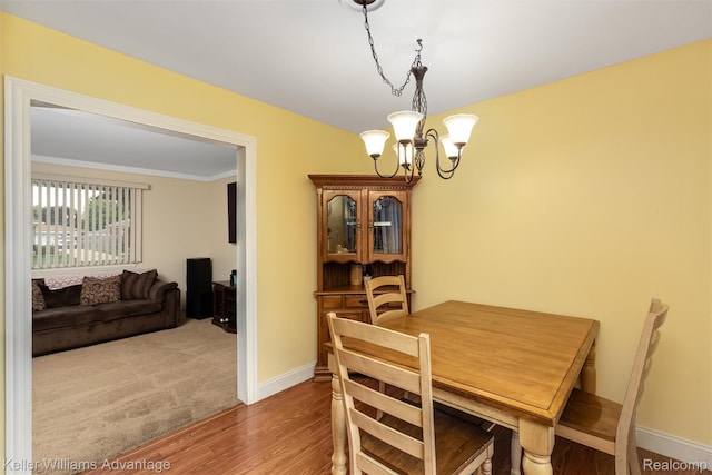 9286 Dudley St, Taylor, MI 48180 - dining space with a chandelier, wood finished floors, and crown molding