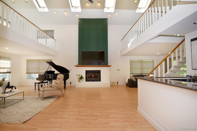 5100 Kings Gate Way, Bloomfield Hills, MI 48302 - living area with a skylight, a towering ceiling, light wood finished floors, a fireplace, and stairs
