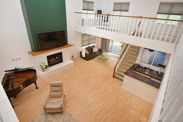 5100 Kings Gate Way, Bloomfield Hills, MI 48302 - living room with wood finished floors, a brick fireplace, and a towering ceiling