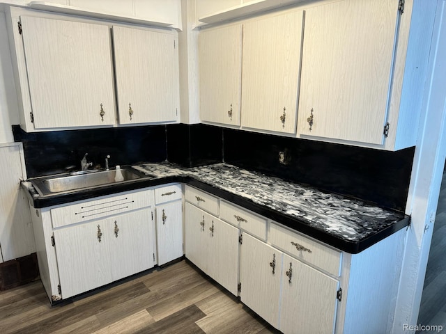 19656 Mitchell St, Detroit, MI 48234 - kitchen featuring wood finished floors and dark countertops