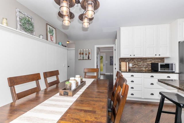 4662 60th St SW, Wyoming, MI 49418 - dining space with a chandelier and dark wood finished floors