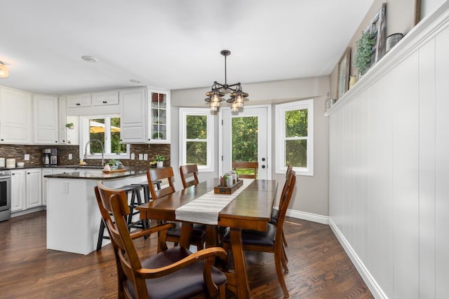 4662 60th St SW, Wyoming, MI 49418 - dining space featuring plenty of natural light, a chandelier, and dark wood-type flooring