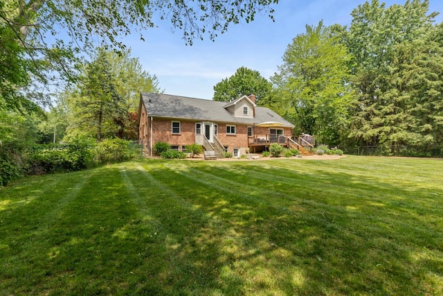 4662 60th St SW, Wyoming, MI 49418 - rear view of property featuring a wooden deck, a chimney, and brick siding