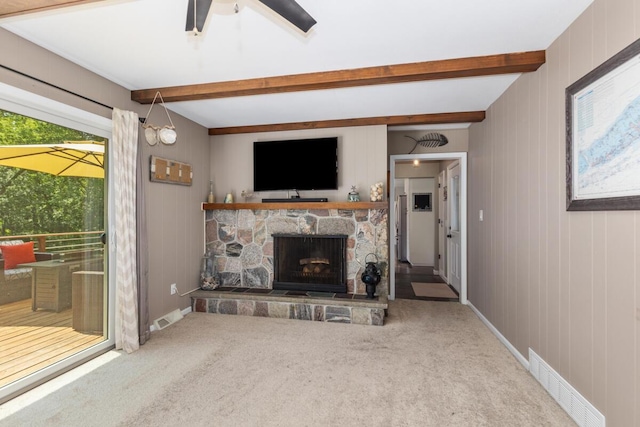 4662 60th St SW, Wyoming, MI 49418 - carpeted living area with beamed ceiling and a stone fireplace