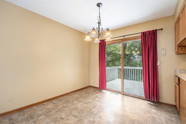 238 Baynton Ave NE, Grand Rapids, MI 49503 - unfurnished dining area featuring a chandelier and stone finish floors