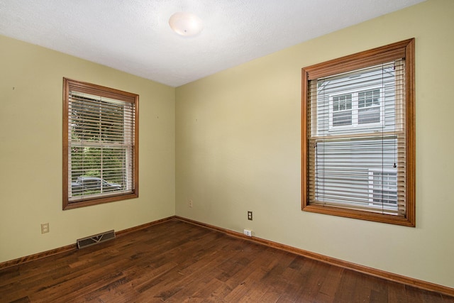 238 Baynton Ave NE, Grand Rapids, MI 49503 - unfurnished room featuring dark wood-style flooring and baseboards