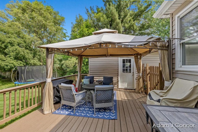 3655 Giddings Ave SE, Grand Rapids, MI 49508 - deck featuring a trampoline, a gazebo, and a yard
