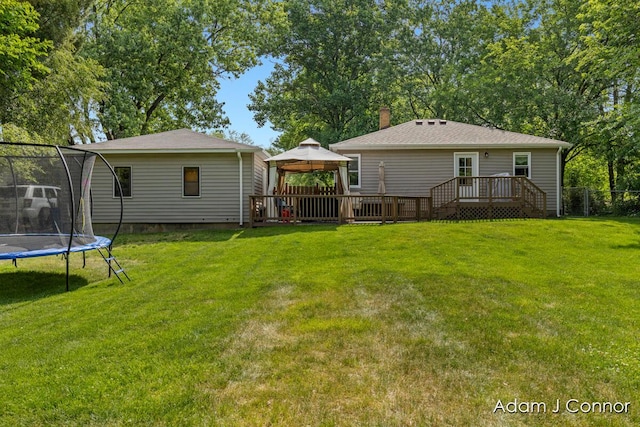 3655 Giddings Ave SE, Grand Rapids, MI 49508 - rear view of house featuring a trampoline, a gazebo, a wooden deck, and a chimney
