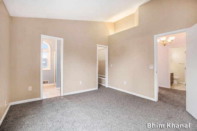 2492 Sunny Creek St SE, Kentwood, MI 49508 - unfurnished bedroom featuring ensuite bath, carpet, and a chandelier