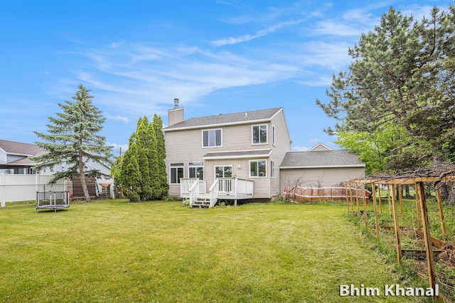 2492 Sunny Creek St SE, Kentwood, MI 49508 - back of house with a chimney, a lawn, a deck, and a trampoline