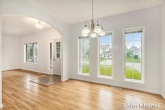 2492 Sunny Creek St SE, Kentwood, MI 49508 - entrance foyer with arched walkways, wood-type flooring, and a chandelier
