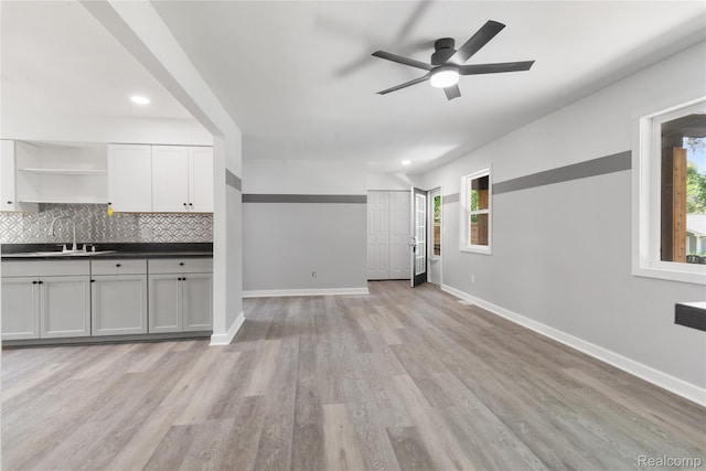 3166 Highland Blvd, Highland, MI 48356 - unfurnished living room featuring light wood finished floors, ceiling fan, and recessed lighting