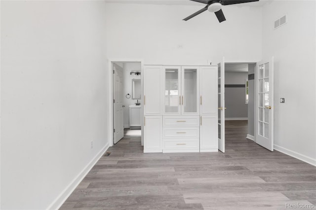 3166 Highland Blvd, Highland, MI 48356 - unfurnished bedroom with high vaulted ceiling, light wood-style flooring, and ceiling fan