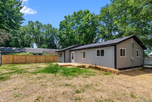 3166 Highland Blvd, Highland, MI 48356 - back of property with a deck and a chimney