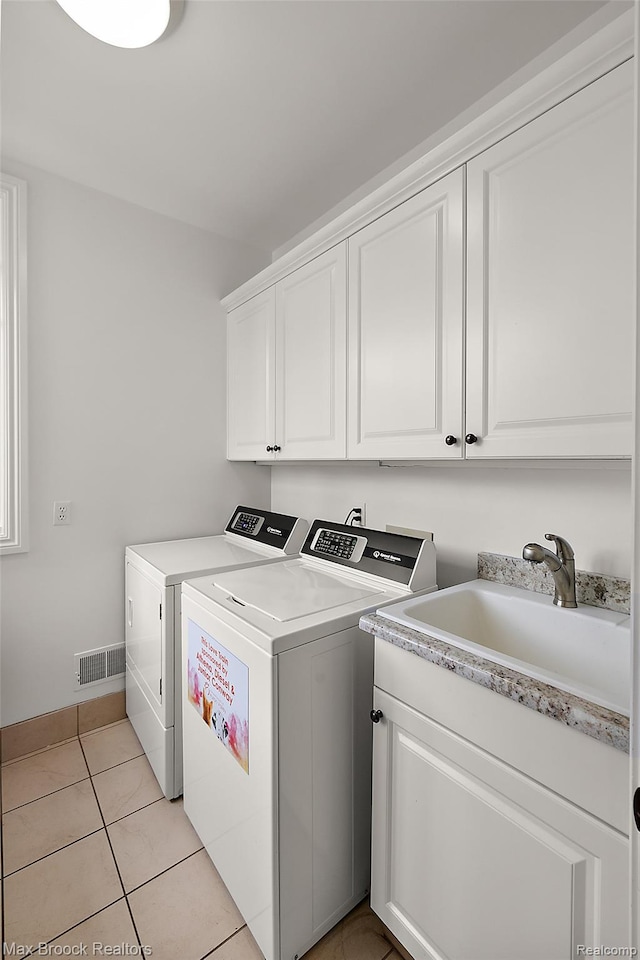 222 Arlington St, Birmingham, MI 48009 - laundry room with washing machine and clothes dryer, cabinet space, and light tile patterned floors