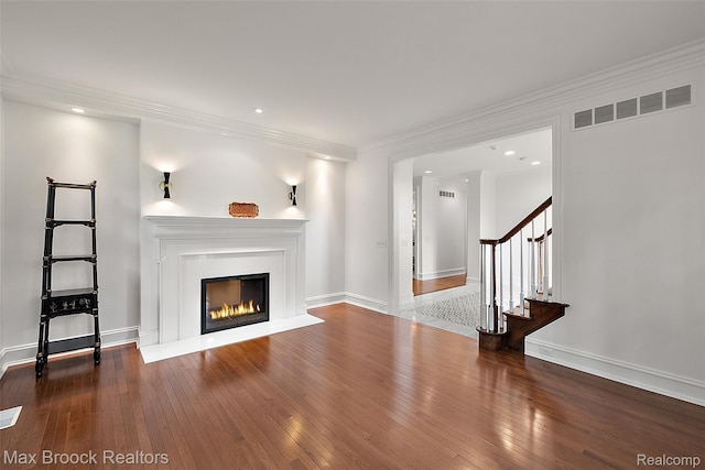 222 Arlington St, Birmingham, MI 48009 - unfurnished living room featuring hardwood / wood-style floors, stairs, a glass covered fireplace, recessed lighting, and crown molding