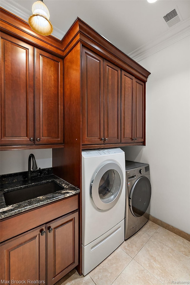 222 Arlington St, Birmingham, MI 48009 - washroom with cabinet space, washing machine and dryer, ornamental molding, and light tile patterned floors
