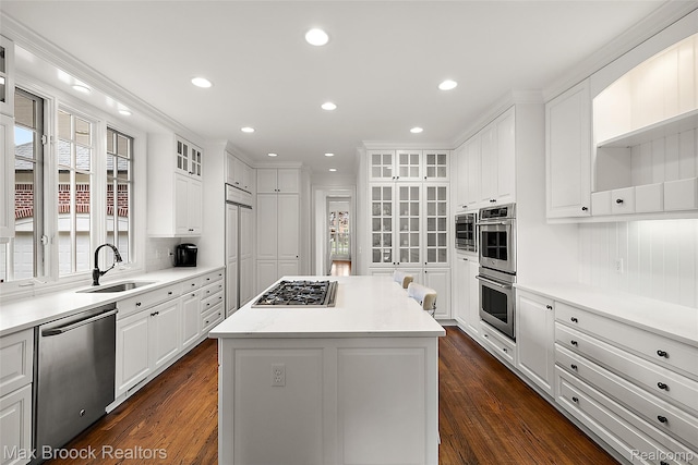 222 Arlington St, Birmingham, MI 48009 - kitchen featuring appliances with stainless steel finishes, white cabinetry, dark wood-style flooring, a kitchen island, and recessed lighting