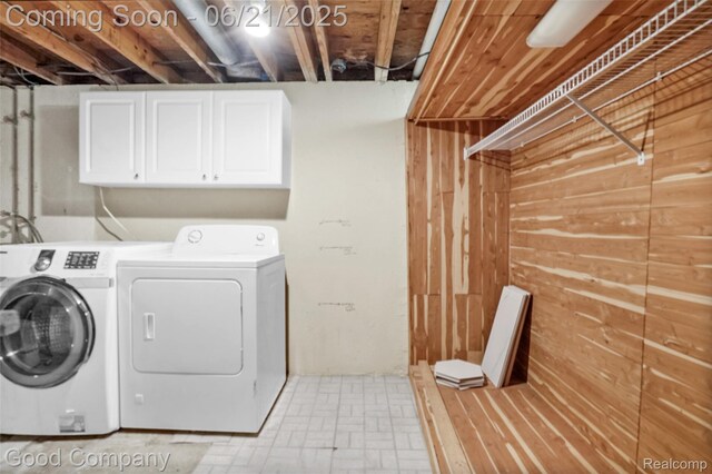 2826 Roundtree Dr, Troy, MI 48083 - laundry room with washing machine and clothes dryer, wooden walls, and cabinet space