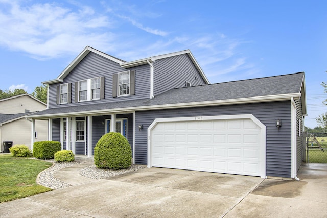 1142 N Peach Ct, Plainwell, MI 49080 - view of front facade featuring driveway, covered porch, an attached garage, and a shingled roof