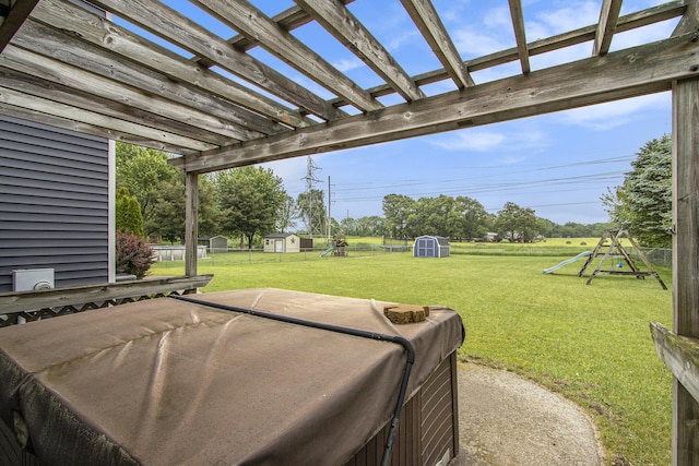 1142 N Peach Ct, Plainwell, MI 49080 - view of green lawn featuring a storage shed, a playground, a pergola, and a patio area