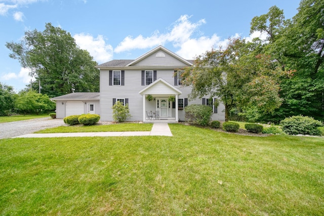14715 Allman Rd, Concord, MI 49237 - colonial inspired home featuring gravel driveway, an attached garage, and a front yard