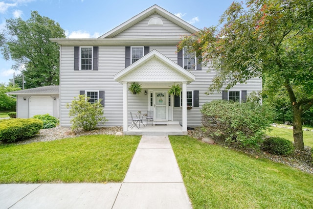 14715 Allman Rd, Concord, MI 49237 - view of front of home with a front yard, an attached garage, and a porch