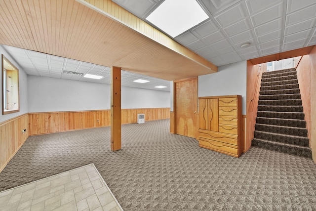 14715 Allman Rd, Concord, MI 49237 - basement with wainscoting, carpet flooring, wooden walls, and stairway