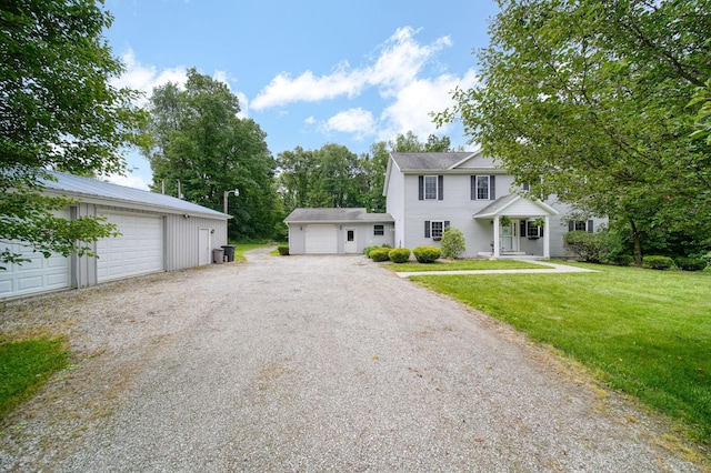 14715 Allman Rd, Concord, MI 49237 - colonial-style house with a detached garage, a front lawn, and an outbuilding